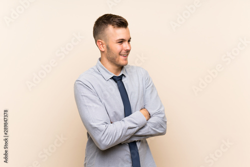 Young blonde businessman over isolated background looking to the side