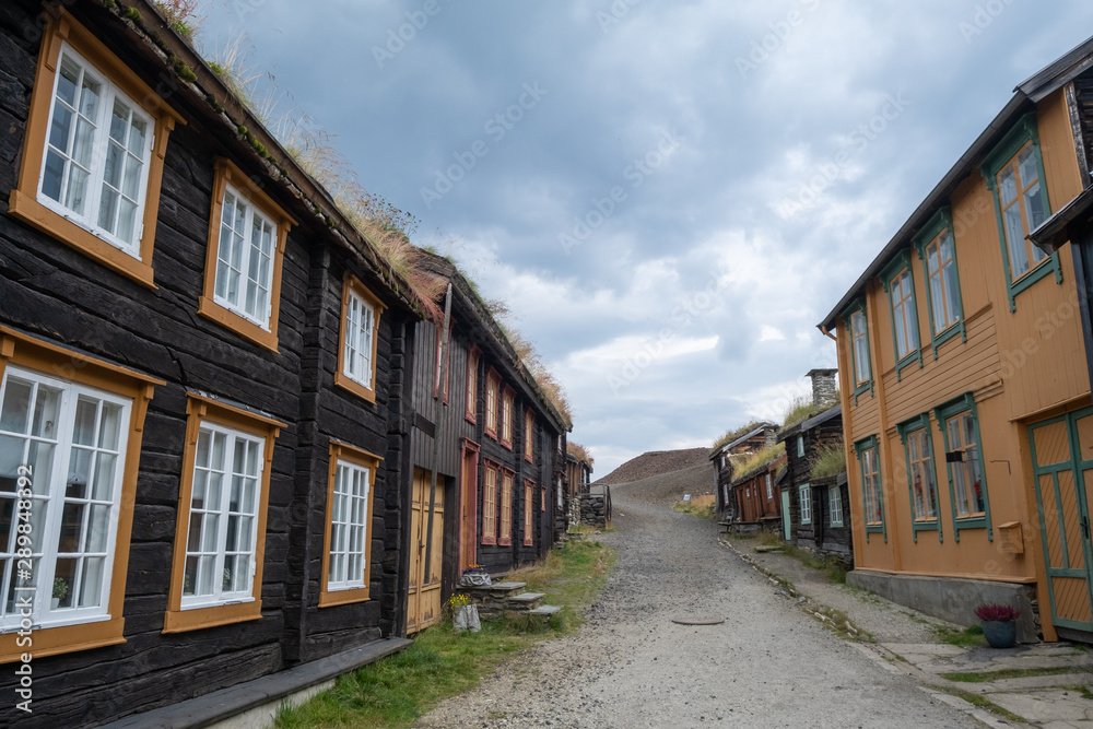 Old street architecture of mining town Roros in Norway. Wooden, colorful buildings. UNESCO world heritage list.