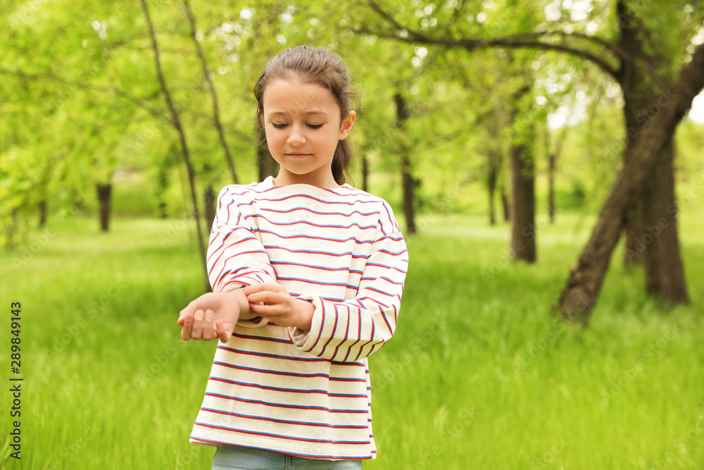 Little girl scratching hand outdoors, space for text. Seasonal allergy Little girl scratching hand outdoors, space for text. Seasonal allergy