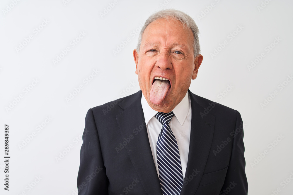 Senior grey-haired businessman wearing suit standing over isolated white background sticking tongue out happy with funny expression. Emotion concept. Senior grey-haired businessman wearing suit standing over isolated white background sticking tongue out happy with funny expression. Emotion concept.