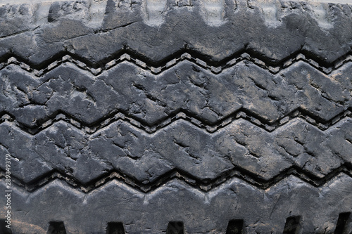 close up old damaged and worn black tire tread truck. Tire tread problems and solutions for road safety concept. Change time. transportation. Write text in the texture background and backdrop.