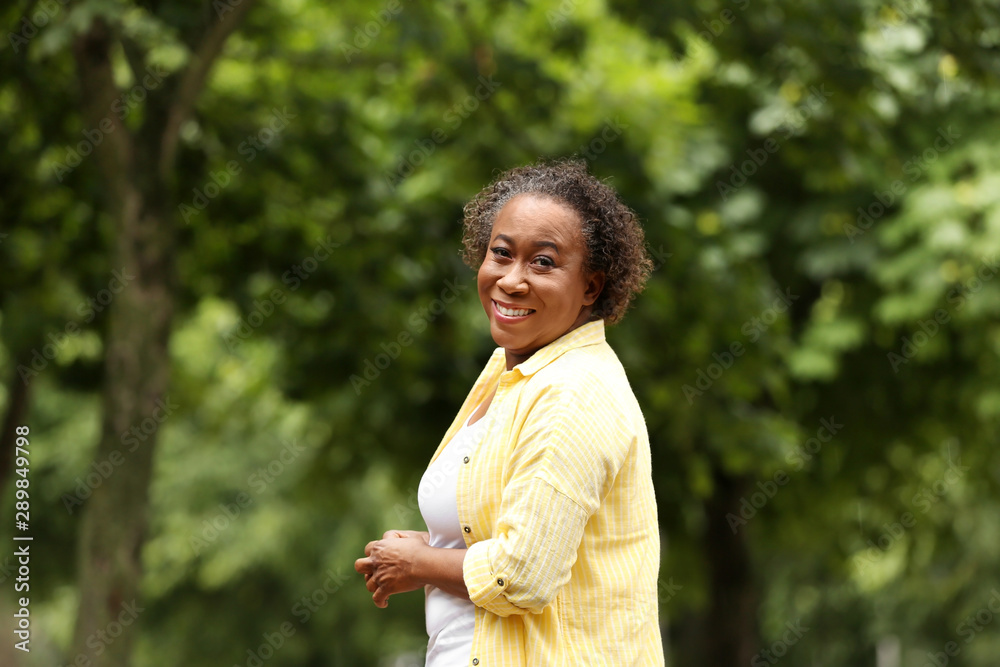 Portrait of happy African-American woman in park Portrait of happy African-American woman in park