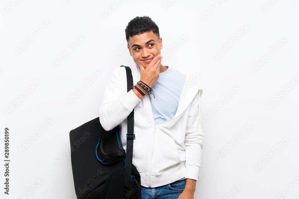 Sport man over isolated white wall thinking an idea Sport man over isolated white wall thinking an idea