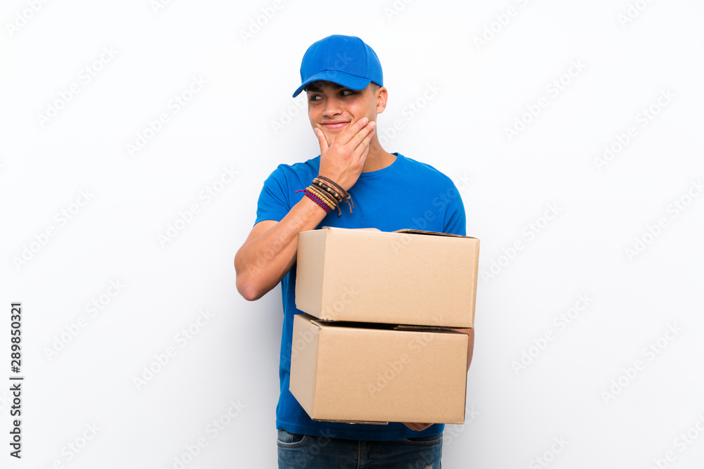 Delivery man over isolated white wall thinking an idea Delivery man over isolated white wall thinking an idea