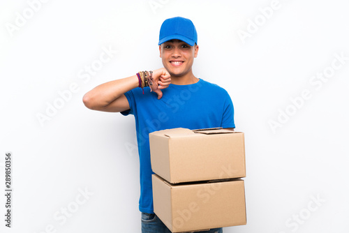 Delivery man over isolated white wall proud and self-satisfied
