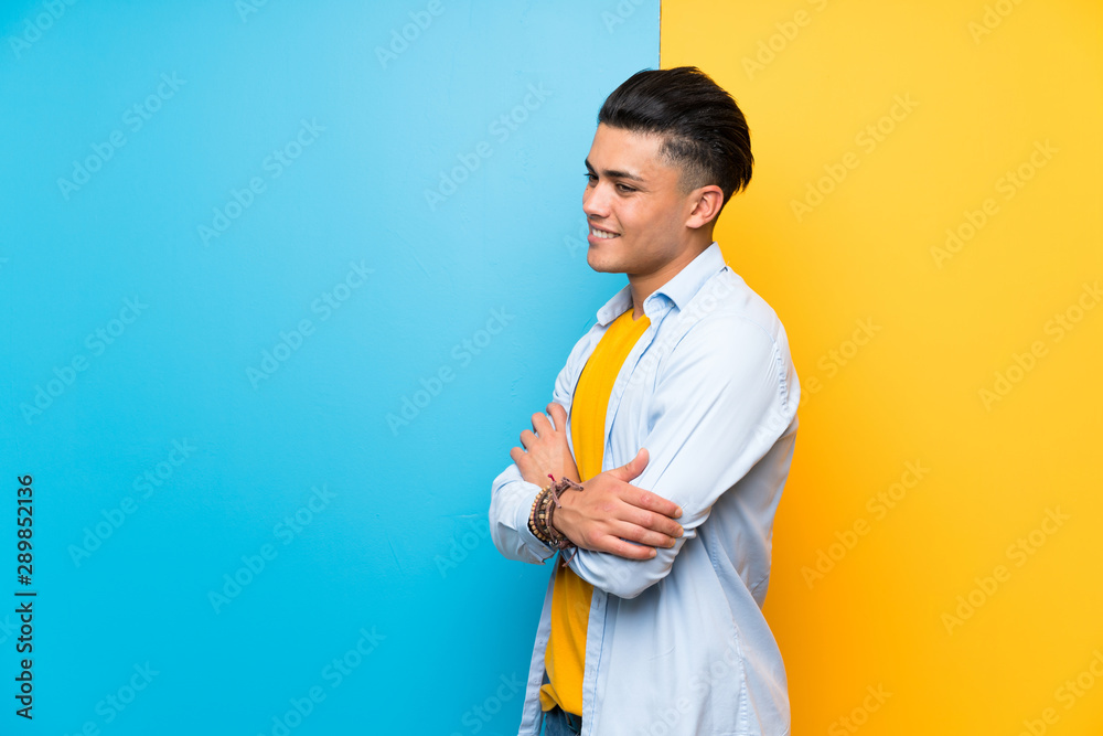Young man over isolated colorful background looking to the side Young man over isolated colorful background looking to the side