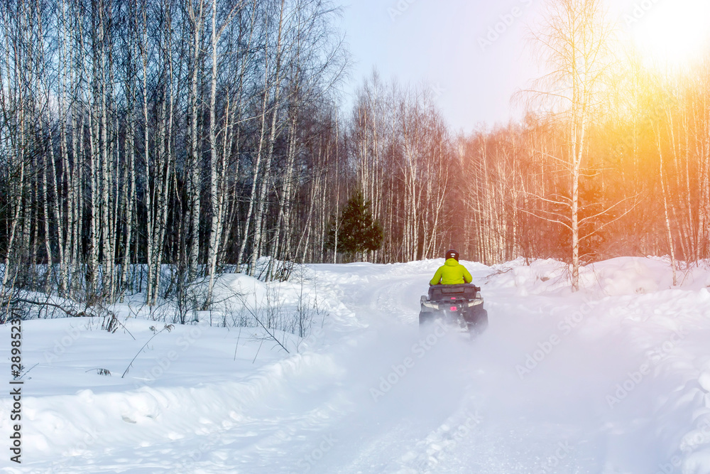 Rider driving in the quad bike race in winter. Rider driving in the quad bike race in winter.