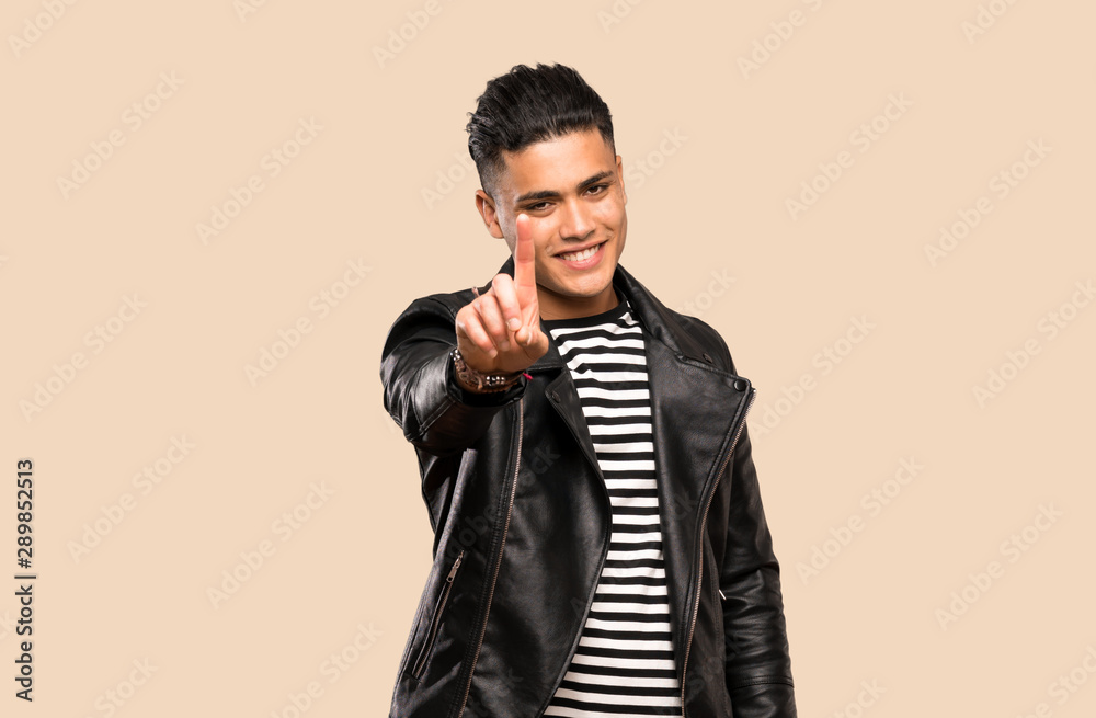 Young man showing and lifting a finger over isolated background Young man showing and lifting a finger over isolated background