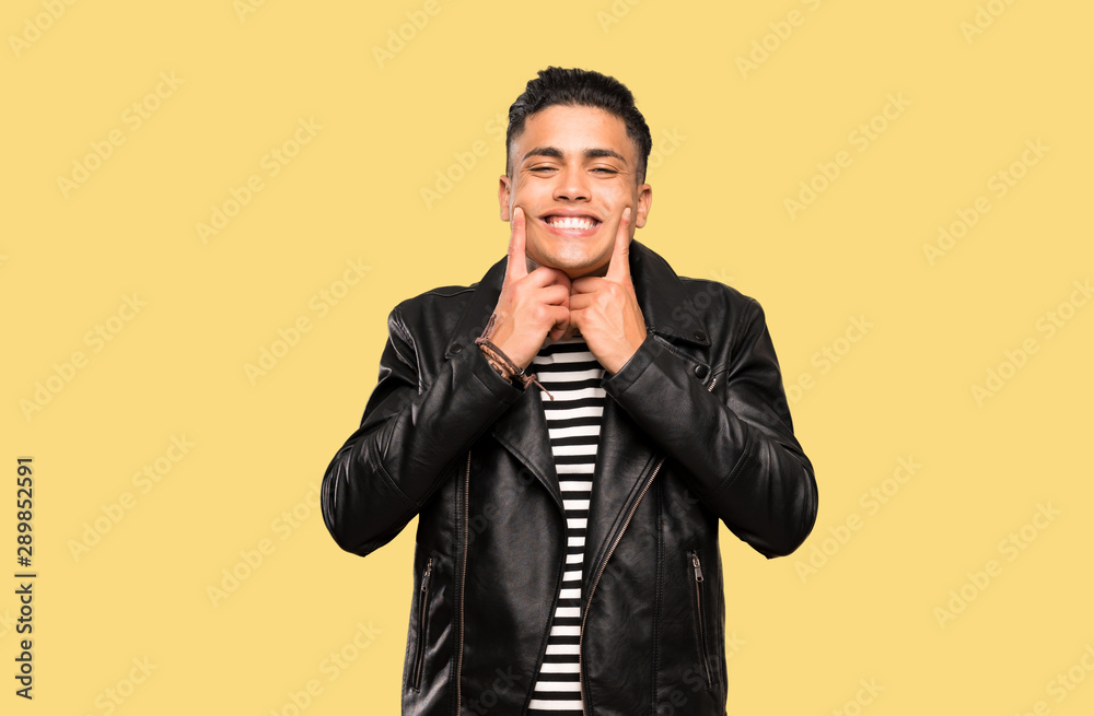 Young man smiling with a happy and pleasant expression over isolated background Young man smiling with a happy and pleasant expression over isolated background