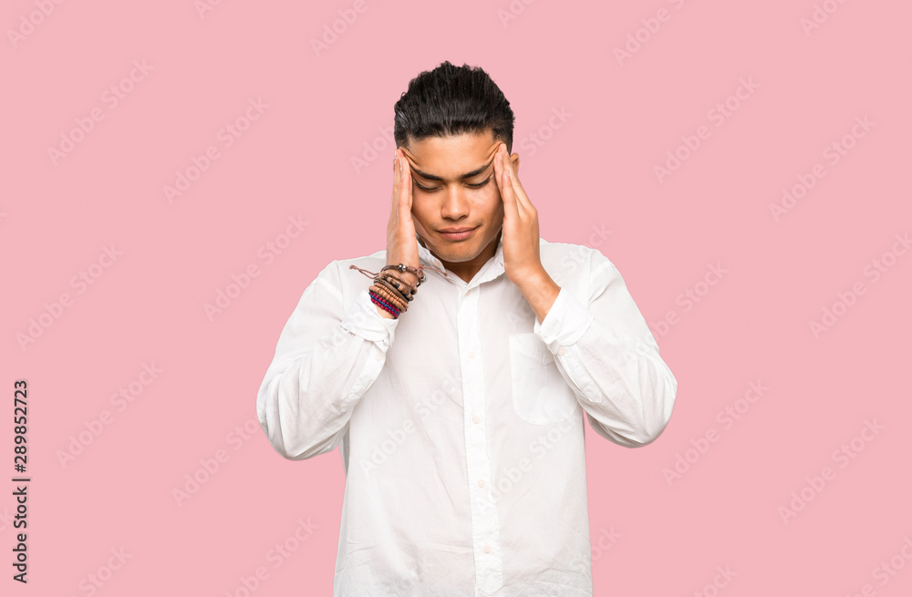 Young man with headache on colorful background Young man with headache on colorful background