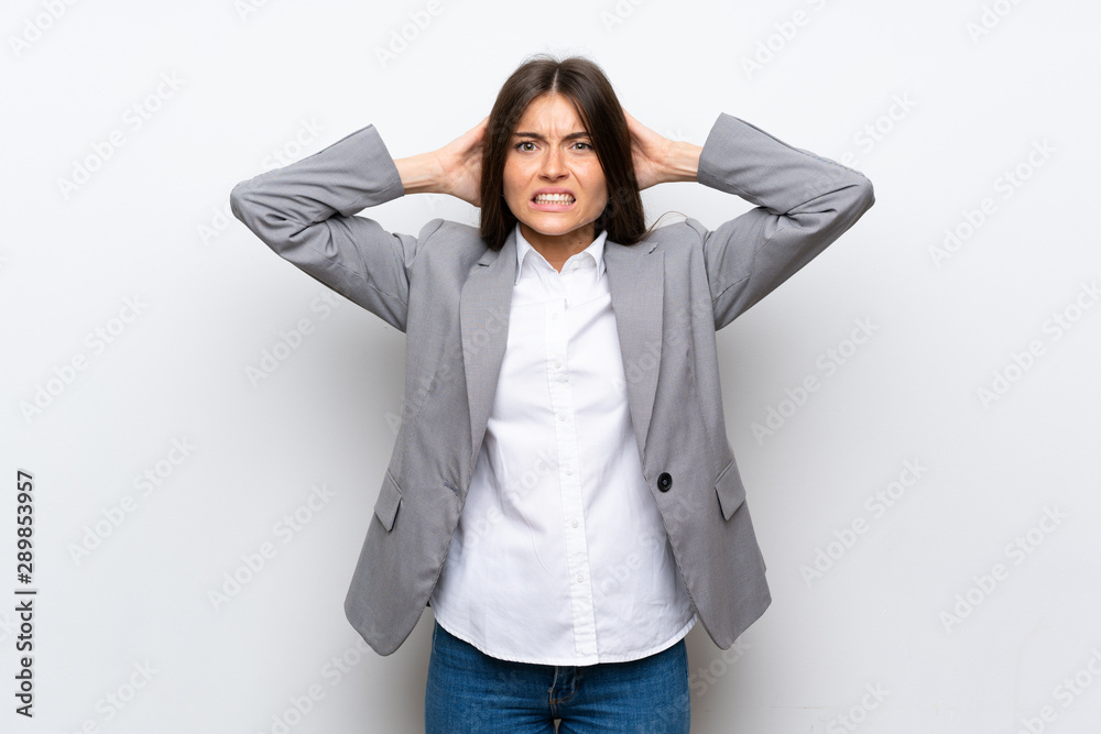 Young business woman over isolated white background frustrated and takes hands on head Young business woman over isolated white background frustrated and takes hands on head