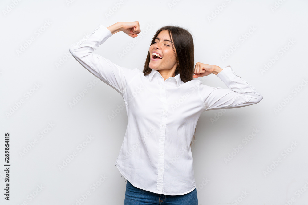 Young woman over isolated white background celebrating a victory Young woman over isolated white background celebrating a victory