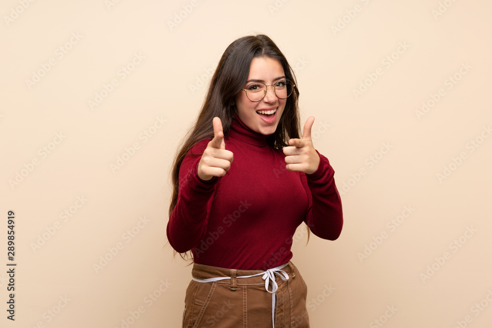 Teenager girl with glasses pointing to the front and smiling Teenager girl with glasses pointing to the front and smiling