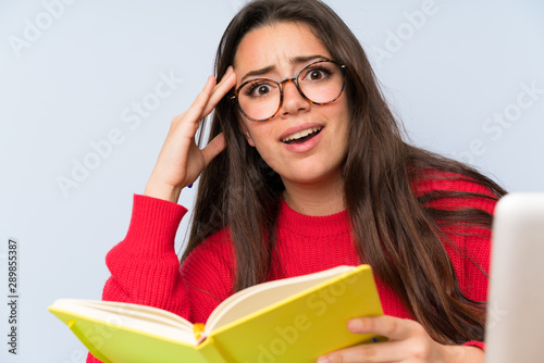 Frustrated Teenager student girl studying in a table