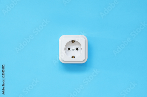 power socket on a blue background, flat lay