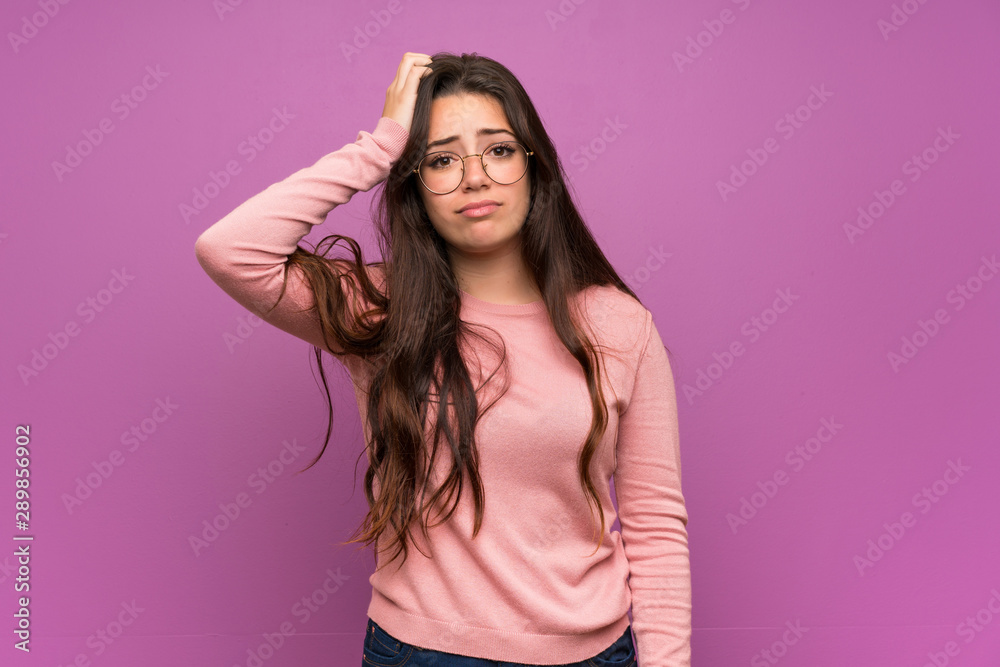 Teenager girl over purple wall with an expression of frustration and not understanding Teenager girl over purple wall with an expression of frustration and not understanding