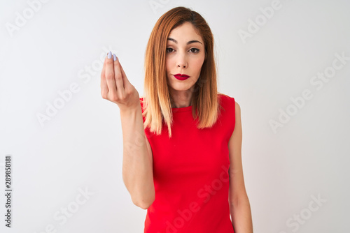 Redhead businesswoman wearing elegant red dress standing over isolated white background Doing Italian gesture with hand and fingers confident expression