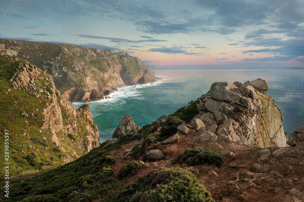 Fototapeta premium Seascape, rocky coast of the Atlantic Ocean, near Cape Roca in Portugal in spring at sunset