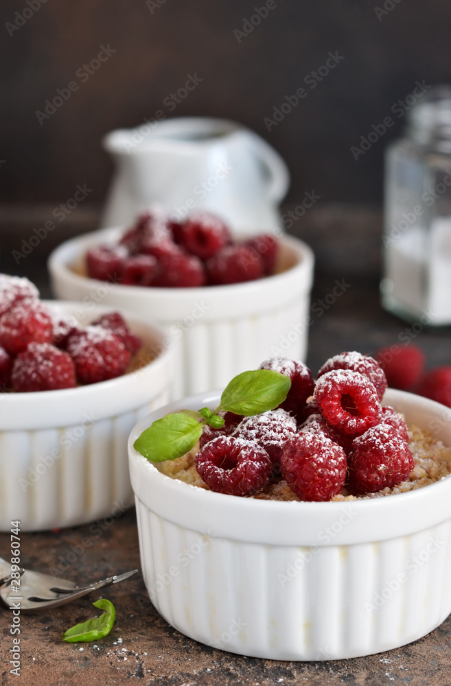 Cheesecake - The classic dessert cheese cream with raspberries. Dessert on the kitchen table. Souffle with cream and berries. Cheesecake - The classic dessert cheese cream with raspberries. Dessert on the kitchen table. Souffle with cream and berries.
