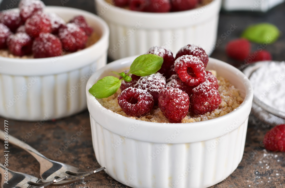 Cheesecake - The classic dessert cheese cream with raspberries. Dessert on the kitchen table. Souffle with cream and berries. Cheesecake - The classic dessert cheese cream with raspberries. Dessert on the kitchen table. Souffle with cream and berries.