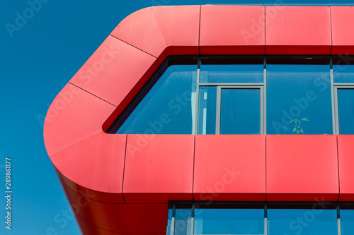 Roof of modern glass and red office building. Background and copy space four your text.