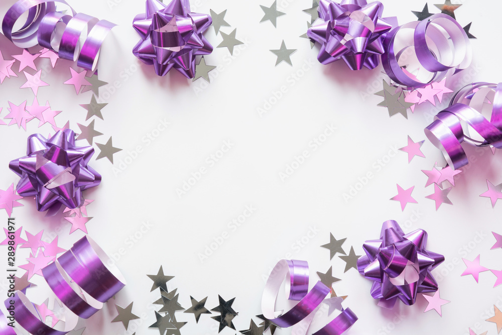 Christmas border of silver and pink pastel decoration, balls , tinsel, star, glitter on white. Xmas. Flat lay style. Top view with copy space