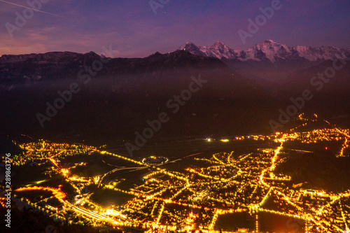 view from Harder Kulm down on Interlaken at night. bright lights in the city surounded by the two lakes Thunersee und Brienzersee photo