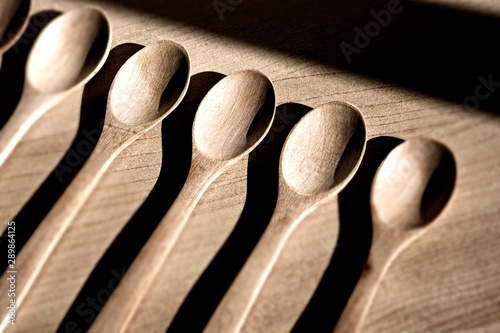 Wooden spoons on table background photo
