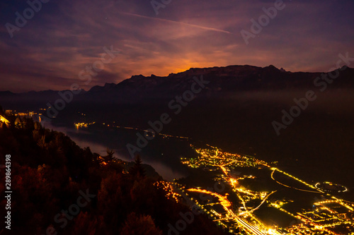 view from Harder Kulm down on Interlaken at night. bright lights in the city surounded by the two lakes Thunersee und Brienzersee photo