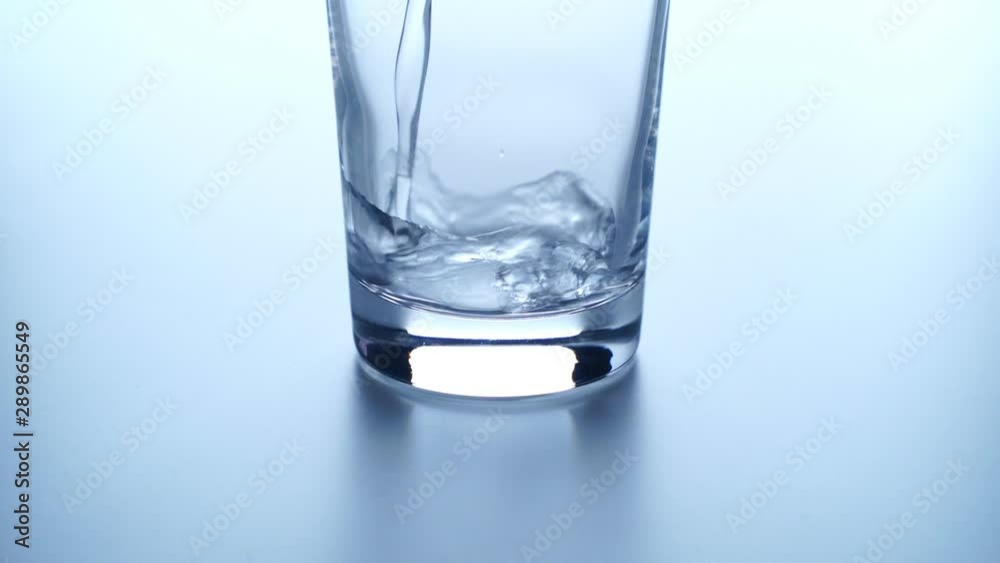 Pouring Water Into Tall Glass. slow motion Pouring Water Into Tall Glass. slow motion