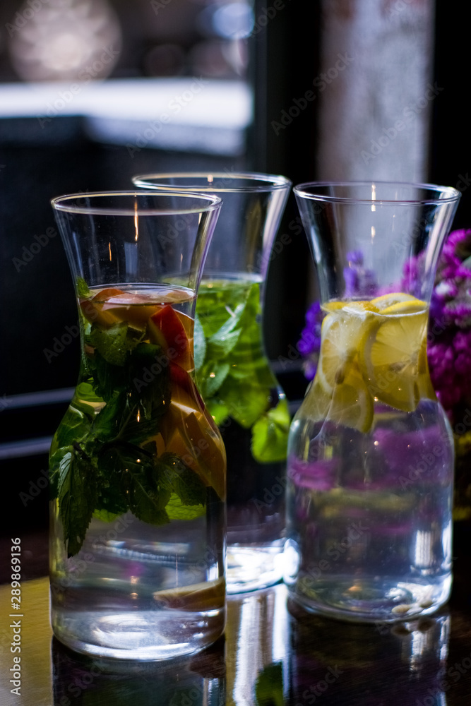 Useful and beautiful water with mint and fruit in glass pitcher. Glasses. Detox. Natural lemonade. Useful and beautiful water with mint and fruit in glass pitcher. Glasses. Detox. Natural lemonade.