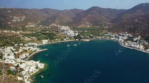 Aerial drone video of iconic port and picturesque village of Katapola in island of Amorgos, Cyclades, Greece