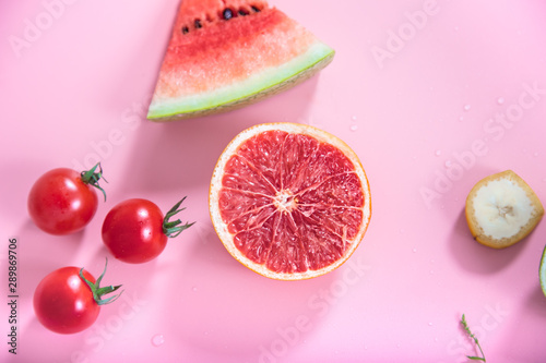 Different fruits and vegetables on a colored background.