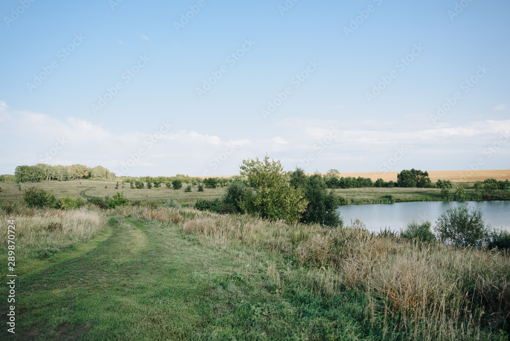summer landscape of fields and lakes with blue sky summer landscape of fields and lakes with blue sky