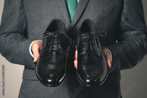 Businessman is choosing a new pair of shoes. © Dmitriy