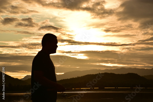 silhouette of woman at sunset