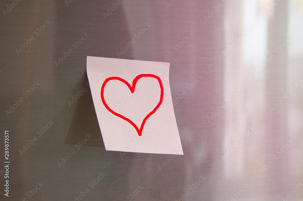 Sticky notes with a heart on the fridge