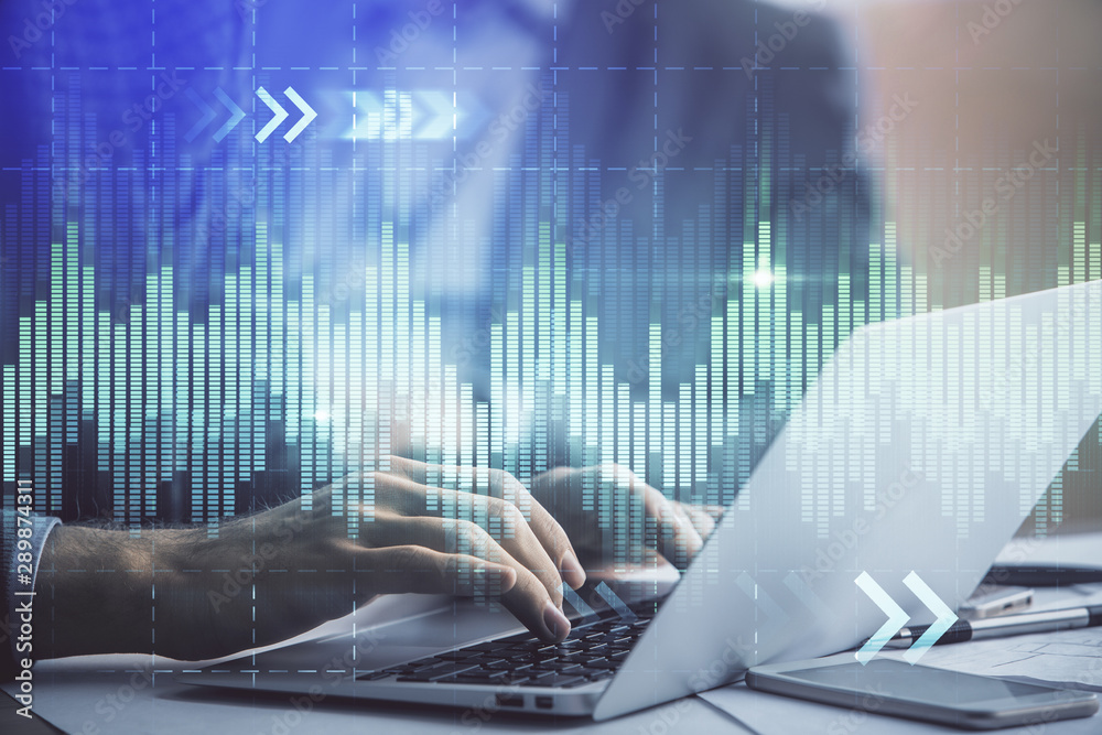 Double exposure of market chart with man working on computer on background. Concept of financial analysis. Double exposure of market chart with man working on computer on background. Concept of financial analysis.