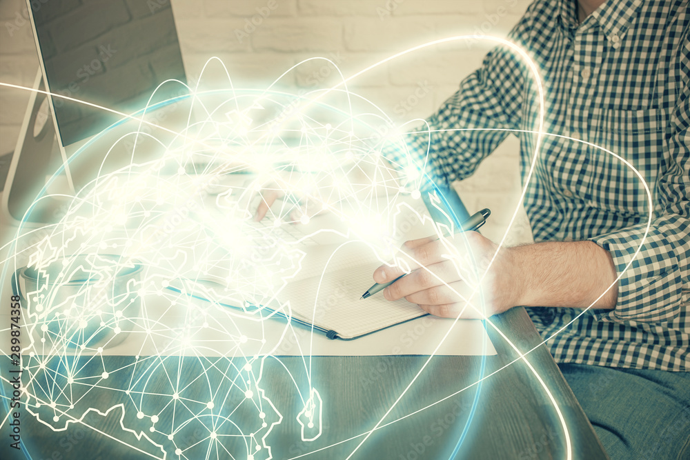 Fototapeta premium Multi exposure of businessman working on laptop on background. International business hologram in front. Concept of success.