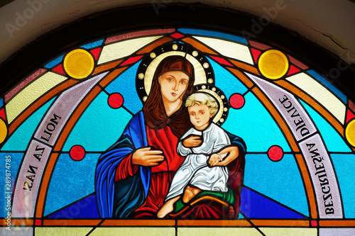 Virgin Mary with baby Jesus, stained glass window in the Shrine of the Our Lady Queen of Peace in Hrasno, Bosnia and Herzegovina