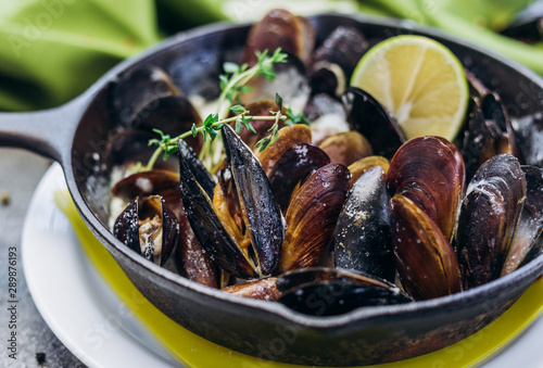 Baked Mediterranean mussels with creamy lime sauce. © Ekaterina Pichukova