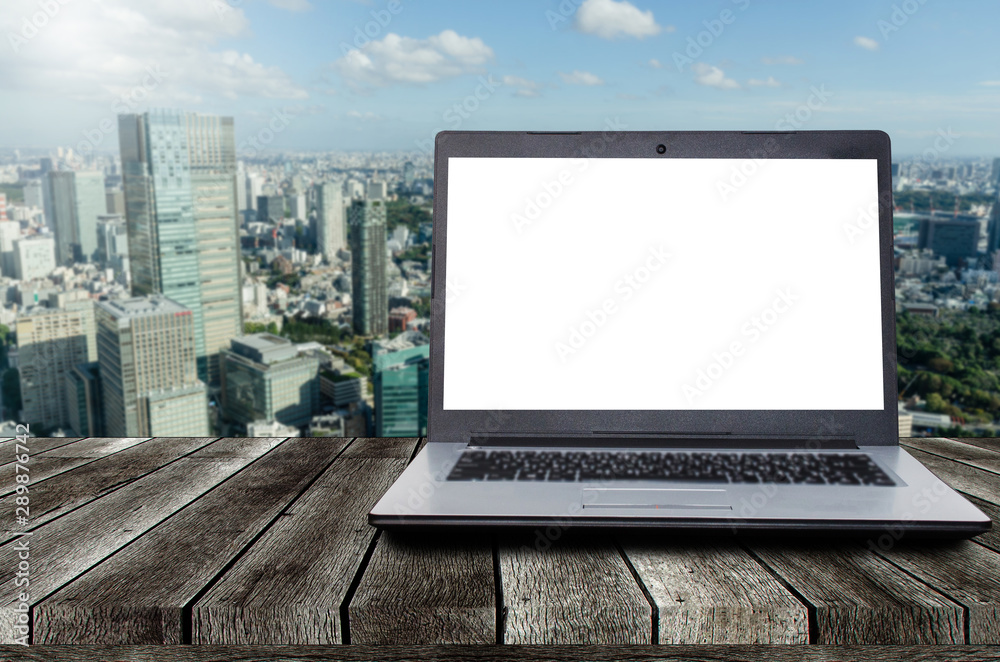 laptop notebook computer with white blank screen on desk with during sunrise and cityscape background, advertisement, workspace, internet technology, online social media and searching data concept laptop notebook computer with white blank screen on desk with during sunrise and cityscape background, advertisement, workspace, internet technology, online social media and searching data concept