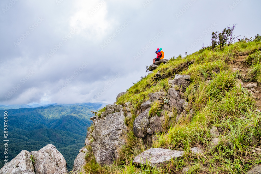 Doi Luang Tak, Tak Province, Thailand. AUGUST 31,2019: Hikers are sitting and happy to the rain forest at Doi Luang Tak,Tak Province,Thailand. Doi Luang Tak, Tak Province, Thailand. AUGUST 31,2019: Hikers are sitting and happy to the rain forest at Doi Luang Tak,Tak Province,Thailand.