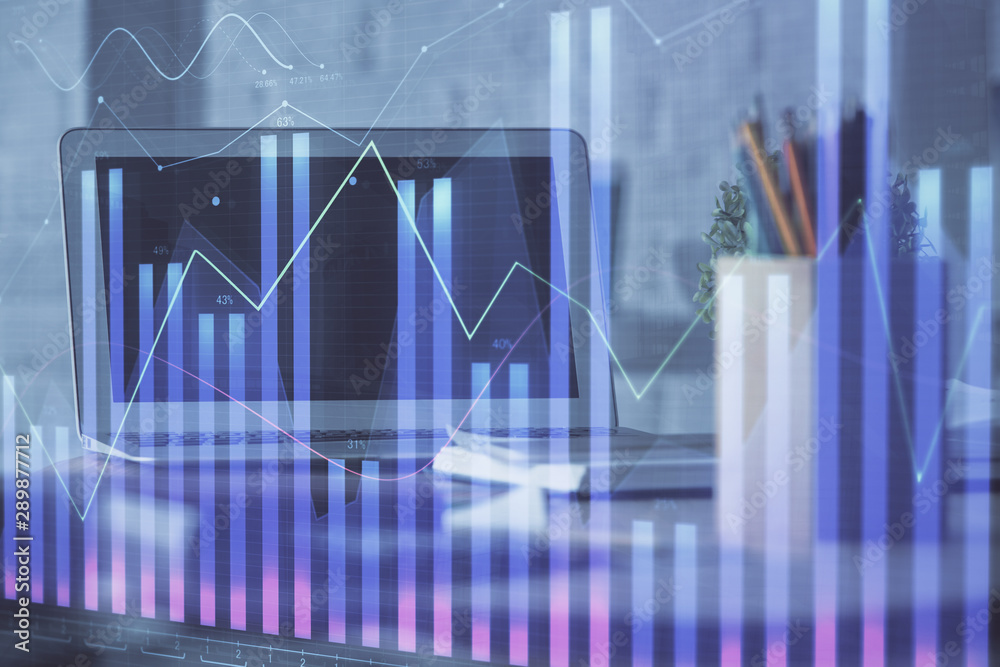 Forex Chart hologram on table with computer background. Double exposure. Concept of financial markets. Forex Chart hologram on table with computer background. Double exposure. Concept of financial markets.