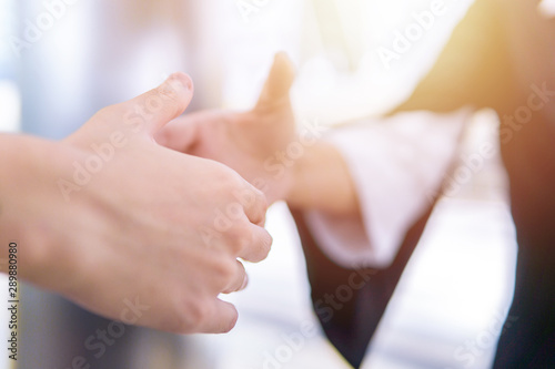 Businesswoman shaking hand with her partner outdoor. Business deal and agreement concept.