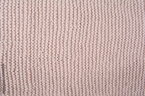 Beige knitted texture fragment. Handmade women hobby
