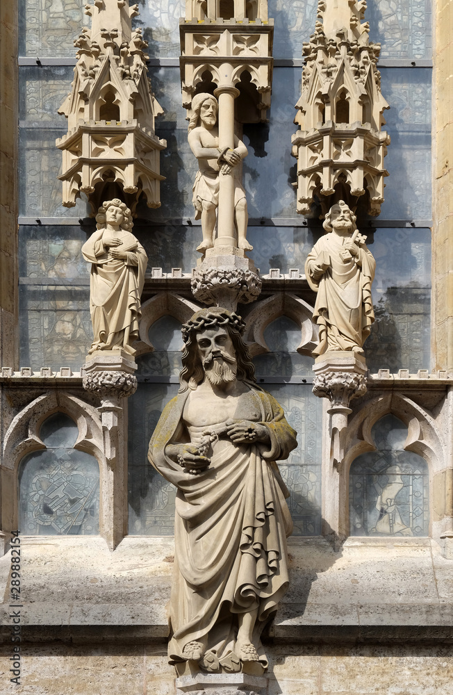 Man of Sorrows with triad, statues on the facade of St James Church in Rothenburg ob der Tauber, Germany