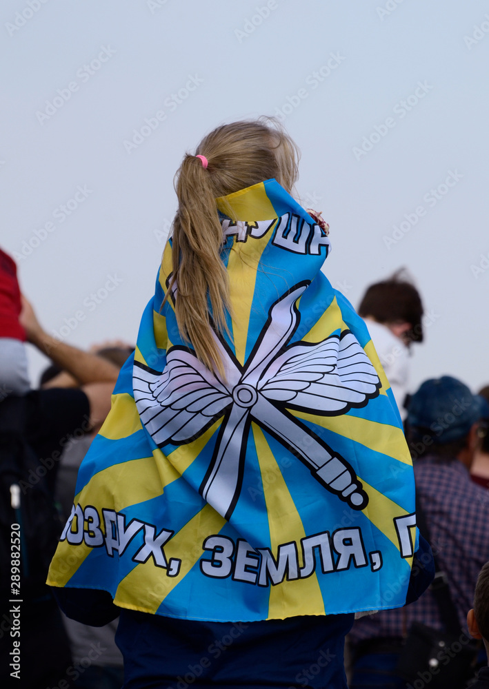 Girl with a Russian flag on her shoulders.