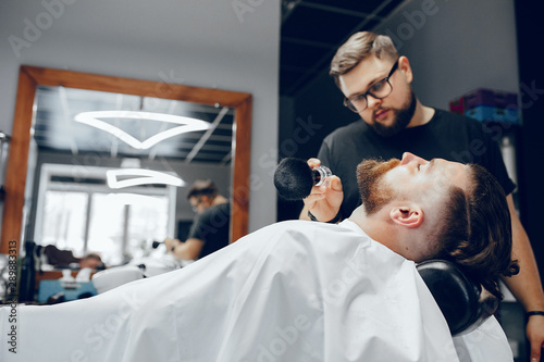 Hairdresser with a client. Man with a beard. Guy in a barbershop