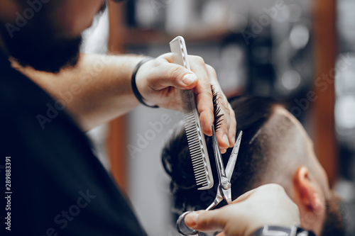 Hairdresser with a client. Man with a beard. Guy in a barbershop